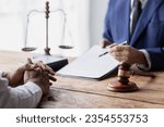 Small photo of justice and law concept. male lawyer working in an office. Legal law, advice, and justice concept. The client is bringing the documents to clarify the law to the lawyer at the prosecutor's office.