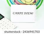 Small photo of The Latin phrase Carpe Diem, a quote from Horace, means seize the moment. Live in the present written on a white card
