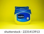 Small photo of Vaseline bottle on yellow background. Skin care product vaseline or petroleum jelly. Afyonkarahisar, Turkey - November 19, 2022.