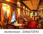 Small photo of Interior of luxury vintage old train carriage. Retro train from the early 20th century. Ruskeala, Karelia, Russia - December 3, 2020