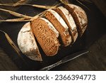 Freshly baked traditional bread on a wooden table. Sliced rye bread, close-up. Food background.