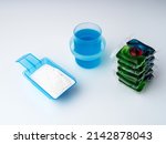Washing powder dispenser with dry washing powder inside, concentrated washing gel and Laundry detergent concentrated in water-soluble capsules