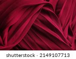 Small photo of Delicate background texture: elegant red silk pleated fabric. Tissue clothing, crimson luxurious dress textile with folds. Burgundy chiffon cloth, 3d waves