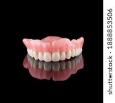 Small photo of Complete maxillary denture in front view with reflection. Color: A3