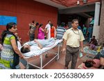 Small photo of New Delhi, India-Aug 11 2021: transporting patient on stretcher at AIIMS hospital. A scene of a General hospital premises on a busy morning where patients are seen transporting to other building