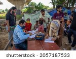 Small photo of New Delhi, India-Oct 10 2021: Doctors team checking local children at Free Health Check up camp The Aim of Health Camp to help Poor Peoples lives in Slum Area at Yamuna Khadar