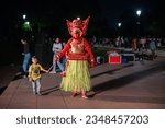Small photo of New Delhi, India-27 May 2023: Theyyam artist blessing child during performing ritualistic dance, Theyyam Performance for public at amphitheatre, India Gate