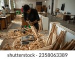 Small photo of Meerut, Uttar Pradesh, India-April 8 2023: A worker carves an unfinished cricket bat at sports manufacturing factory in Meerut, a largest sports manufacturer, producer of sports gear and equipment.
