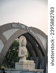 Small photo of Noida, Uttar Pradesh, India-Dec 2 2023: A vertical photo of Gautam Buddha gate or Noida entry gate near Sector 14A, where Goutam Buddha Statue in Meditation posture doing welcome, Delhi Noida border.