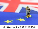 Risk of Brexit or the withdrawal of the United Kingdom from the European Union : Miniature family hug each other on EU and UK flags, depict risk & impact on bilateral UK relation e.g economic, finance