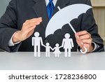 Small photo of Family life insurance, financial security concept : Businessman protects family members e.g parents and two child, depicts protection from insurer, they will pay a lump sum for clearing burden of debt