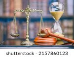 Small photo of Legal office of lawyers, justice and law concept : Retro balance scale of justice on a desk in a courtroom, depicting giving fair and objective consideration to all evidence, without showing bias.