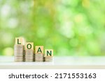 Small photo of Personal loan agreement and non-performing assets, financial concept : Word LOAN on rows of coins, depicts long or short-term money borrowing between borrower and lender binded via a promissory note.