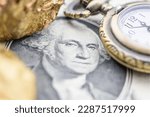 Small photo of Precious metals and currency investment concept : Gold iron ore on a US dollar money, depicting investing in gold market to diversify risk through the use of ETFs futures contract and derivatives.