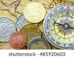 Small photo of Ancient compass and coins on an old treasure map. An idea of finding / seeking / managing the right or appropriate ways to gain more wealth on plenteous / numerous financial instruments nowadays.