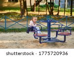 Little girl rides on a swing...