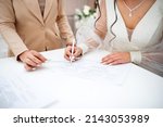 Small photo of The bride signs the marriage in the department of state registration of civil status