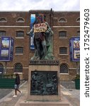 Small photo of TOWER HAMLETS, LONDON, UNITED KINGDOM. JUNE 9TH 2020: Robert Milligan Statue outside The Museum of London, Docklands with Head Covered by a Scarf, Holding a Handmade Sign Stating 'Black Lives Matter'.