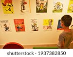 Small photo of A little boy looking at different multilingual book covers of Pippi Longstocking books at Astrid Lindgren's World theme park, Vimmerby, Sweden.