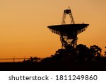 Small photo of Close up isolated silhouette image of a large radio telescope antenna used for deep space exploration in Wallops Flight Facility of NASA The large satellite dish is facing towards the sky.