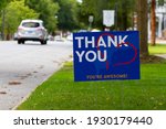 Small photo of a yard sign by street saying "Thank you, you are awesome" in white and orange text on blue background. A red heart symbol is embedded. Customizable versatile image with copy space for additional text
