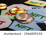 A concept image for investing in Non Fungible Tokens (NFTs) through Ethereum blockchain. These are rare digital items that are traded online. Image shows NFTs with ETH coins on dark background
