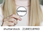 Small photo of Medicine and health concept. Estrogen inscription on the stethoscope in the hands of a girl doctor, close-up of the hand