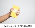 Hand holding a sponge with a...