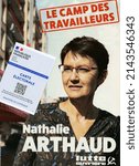Small photo of Paris, FRance - 07-04-2022: A french voter's card is seen on the candidate's flyer Nathalie Arthaud