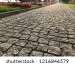 Stone pavement in perspective. Stone pavement texture. Granite cobblestoned pavement background. Abstract background of a cobblestone pavement close-up