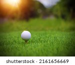 Small photo of Golf ball close up on tee grass on blurred beautiful landscape of golf background. Concept international sport that rely on precision skills for health relaxation.