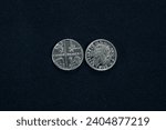 Small photo of Two-sided five pence coin on black background.