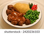 Small photo of These juicy and flavorful Swedish Meatballs are smothered in a savory gravy cream sauce and are perfect over noodles or mashed potatoes.