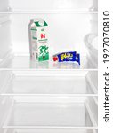 Small photo of MOTALA, SWEDEN- 18 MAY 2012: An almost empty refrigerator with only a milk package and a tube of Kalle's caviar