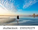 Girl Walking On The Beach At...
