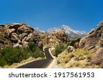 The rocks of "Alabama Hills" with a winding road and the Sierra Nevada in the background.