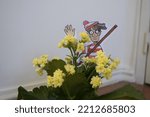 Small photo of Lisbon, Portugal - October 11th, 2022: Watercolor illustration of Wally (Waldo) hidden inside a house (in a vase of yellow flowers). Character from the book "Where's Wally?".