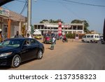 Small photo of BAKAU, THE GAMBIA - FEBRUARY 6, 2022 traffic at the Jah Oil station on Old Cape Road