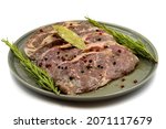 Marinated beef ribeye on a white background. Beef entrecote marinated with olive oil and various spices