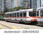 Small photo of Tuen Mun, Hong Kong - August 23, 2023: Hong Kong New Territories Light Rail Transit phase I, II, III on route 610 and 615.