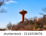 Blue sky and brown rusty UFO-like water tower