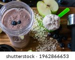 Fitness Breakfast Smoothie with fresh blueberries and apples blended with oatmeal and whey protein powder served in a drinking cub