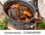 Small photo of Meatloaf with brown sauce and vegetables in a rustic pot. Traditional german "Falscher Hase"
