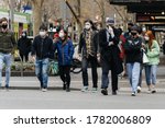 Small photo of Melbourne, Victoria, Australia - July 23rd 2020: People don masks en masse on the first day of Victoria's mask rule. Crossing the street in the CBD, everyone in sight is now wearing a mask.
