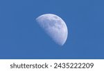 Small photo of The waning moon in the evening in winter with blue sky