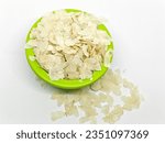 Small photo of Flattened rice also known as parched or beaten rice, Flattened rice commonly known as Avalakki in Canada, Raw Flattened thin Rice Flakes for Namkeen Chivda snacks or Aloo Poha bowl isolated on white