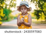 A child catches a butterfly in...