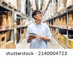 Portrait of smiling asian engineer foreman in helmets man order details checking goods and supplies on shelves with goods background in warehouse.logistic and business export