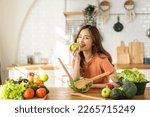 Small photo of Portrait of beauty body slim healthy asian woman having fun cooking and preparing cooking vegan food healthy eat with fresh vegetable salad in kitchen at home.Diet concept.Fitness and healthy food