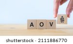 Small photo of Increase average order value (AOV) concept. Strategy to get more money per oder. Order minimum, free shipping, bundle, upsell, cross sell, crm. Hand put wooden cubes with increase sales per order icon